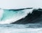 Mesmerizing closeup shot of huge turquoise wave in stormy ocean. Concept of surfing