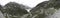 Mesmerizing panoramic shot of the beautiful road among the rocky mountains