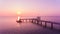 Mesmerizing pink sunset over the horizon of the sea with a pier