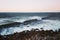 Mesmerizing scenary of sea waves hitting rocks on the beach