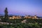 Mesmerizing scene of the Alhambra Palace with the mountains in the background at sunset