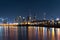 Mesmerizing scenery of Kuwait City at night, with tall skyscrapers reflected in the water