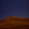 Mesmerizing scenery of the sand dunes against the magical night sky background