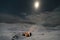 Mesmerizing shot of a group of people next to the bonfire in Greenland at night