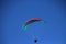 Mesmerizing shot of a male flying with a parachute high in the sky