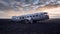 Mesmerizing shot of an old crashed airplane in the middle of a field under the beautiful sky