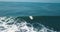 Mesmerizing shot of a surfer at the top of the wave in El Paredon beach in Monterrico, Guatemala