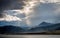 Mesmerizing sun rays coming behind the fluffy clouds in the mountains