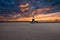 Mesmerizing sunset sky with a dense grey cloudscape captured above a lighthouse in Aarhus, Denmark