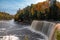 Mesmerizing Tahquamenon Falls waterfall in Michigan surrounded by autumn foliage