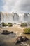 Mesmerizing vertical landscape of Iguacu Falls on a bright sunny day