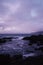 Mesmerizing view of rocks in the ocean under the purple sky  located in Lion Park, Taiwan