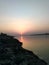 A mesmerizing view of sunset clicked from back of a river