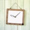 Message board of dollar sign clock hanging on wooden wall