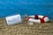 Message in a bottle with the german word for time-out or break - Auszeit on sand with lifebuoy and blue weathered wood