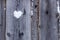 Message of a loved one with a symbol in the shape of a heart fashioned from snow on a wooden fence on Valentine`s Day