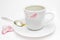 Messthetics aesthetic concept. A photo of the red lipstick marks on your coffee cup. Dirty empty white ceramic cup on the plate, s