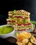 Messy Bombay masala sandwich with beetroot, potato and vegetable filling, with a green chili mint coriander dip and chips, served