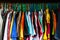 Messy closet overfilled with colorful woman clothes on hangers