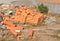 Messy construction site: a pile of red brick, staked bricks among construction waste or building garbage