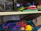 A messy disorganised school games storage cupboard