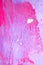Messy paint strokes and smudges on an old painted wall. Pink, purple color drips, flows, streaks of paint and paint