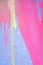 Messy paint strokes and smudges on an old painted wall. Purple, blue, pink, magenta, yellow drips, flows, streaks of