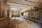 Messy storage, former stable with damaged walls in old country house