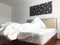 Messy or unmade hotel bed or house bedroom, interior design