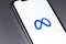 Meta logo on screen smartphone, iPhone closeup