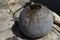 Metal anchor bell on a concrete wharf