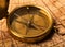 Metal antique compass on background