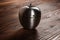 Metal apple kitchen timer on wooden background