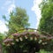 metal arch with baskets of flowers. Decor element. Landscape decoration, landscaping