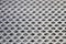 Metal background pattern.Abstract metal texture plate hole.Silver stainless grid for industrial