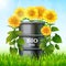 Metal barrel with bio fuel and sunflowers on the green grass