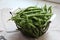 Metal basket with green beans, harvested green beans, green vegetables