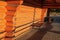 Metal bench in log cabin porch under evening sun light