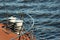 Metal bollard with mooring lines on deck of a ship.