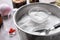 Metal bowl with bath bomb mixture, mold and spoon on table, closeup