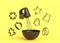 Metal bowl with electric mixer and cookie cutters on monochrome background
