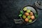 Metal bowl with sliced kiwi. Fruits.