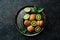 Metal bowl with sliced kiwi. Fruits. On a stone background.