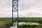 Metal bridge over a small river in cloudy weather.