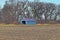 Metal Building at the Edge of a Plowed Field