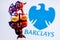 Metal bull stands on buy-sell dices on background of Barclays bank logo