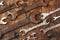 Metal bunch wrench rusty iron metal tools lying on dark wooden t