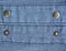 Metal buttons on jeans background