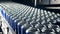 Metal cans with beer on an assembly line, close up.