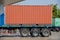 A metal cargo container on Truck trailer parked. Container on trailer. Container at the Dock with Truck